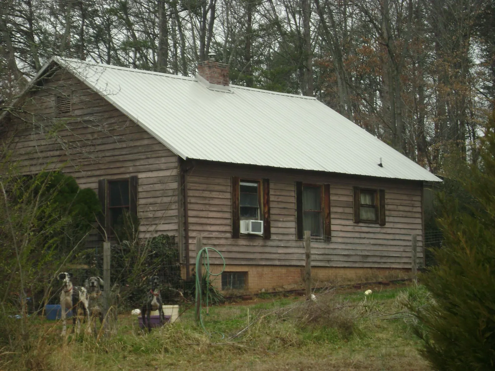 White metal roof on an old wood sided farmhouse, from a Metal Roof Installation job in Schwertner